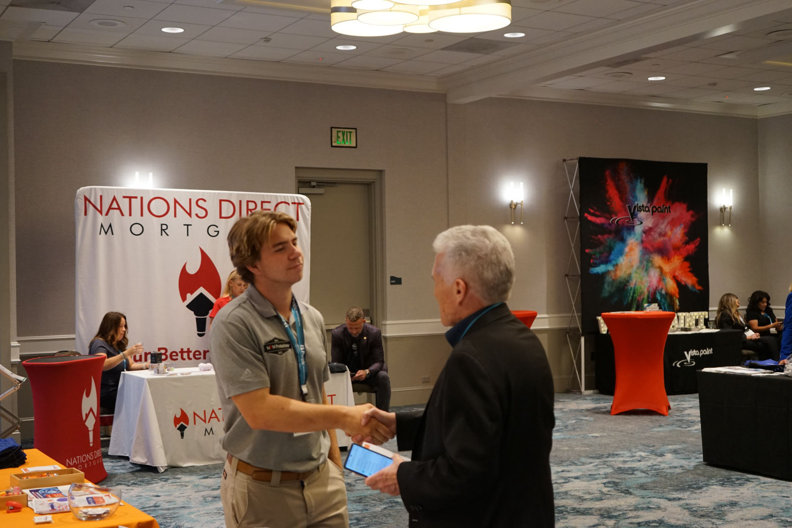 Pierce shaking hands with an expo attendee