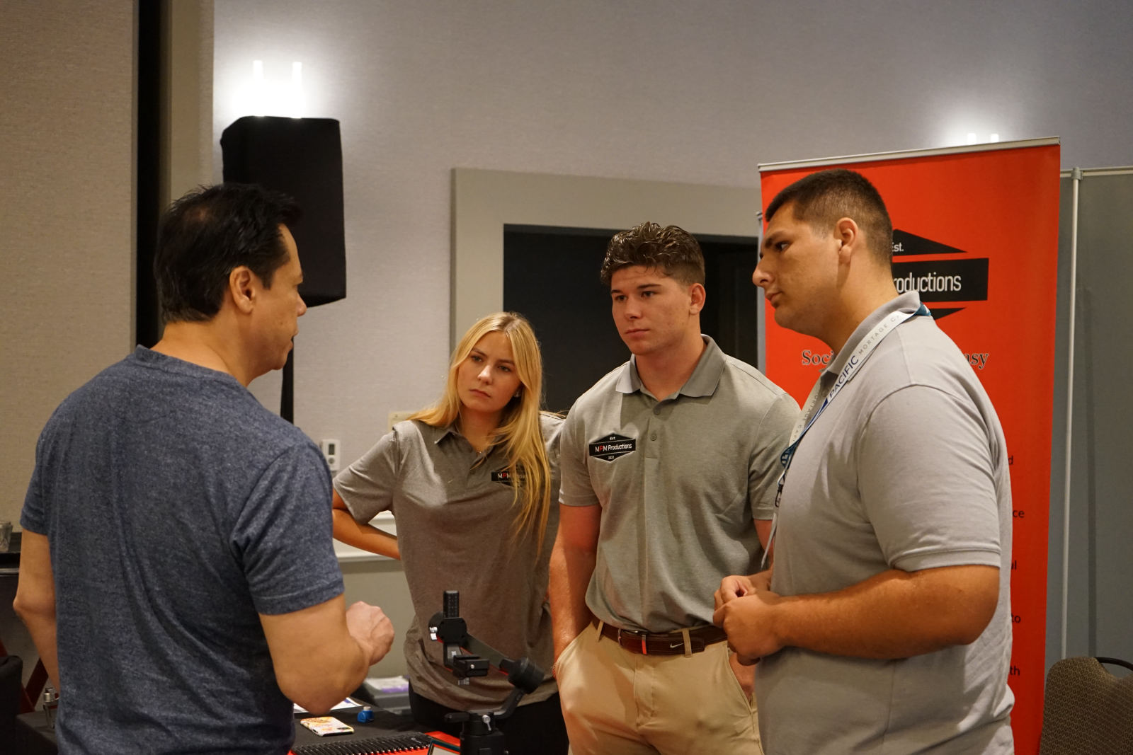 The team talking with visitors at the booth